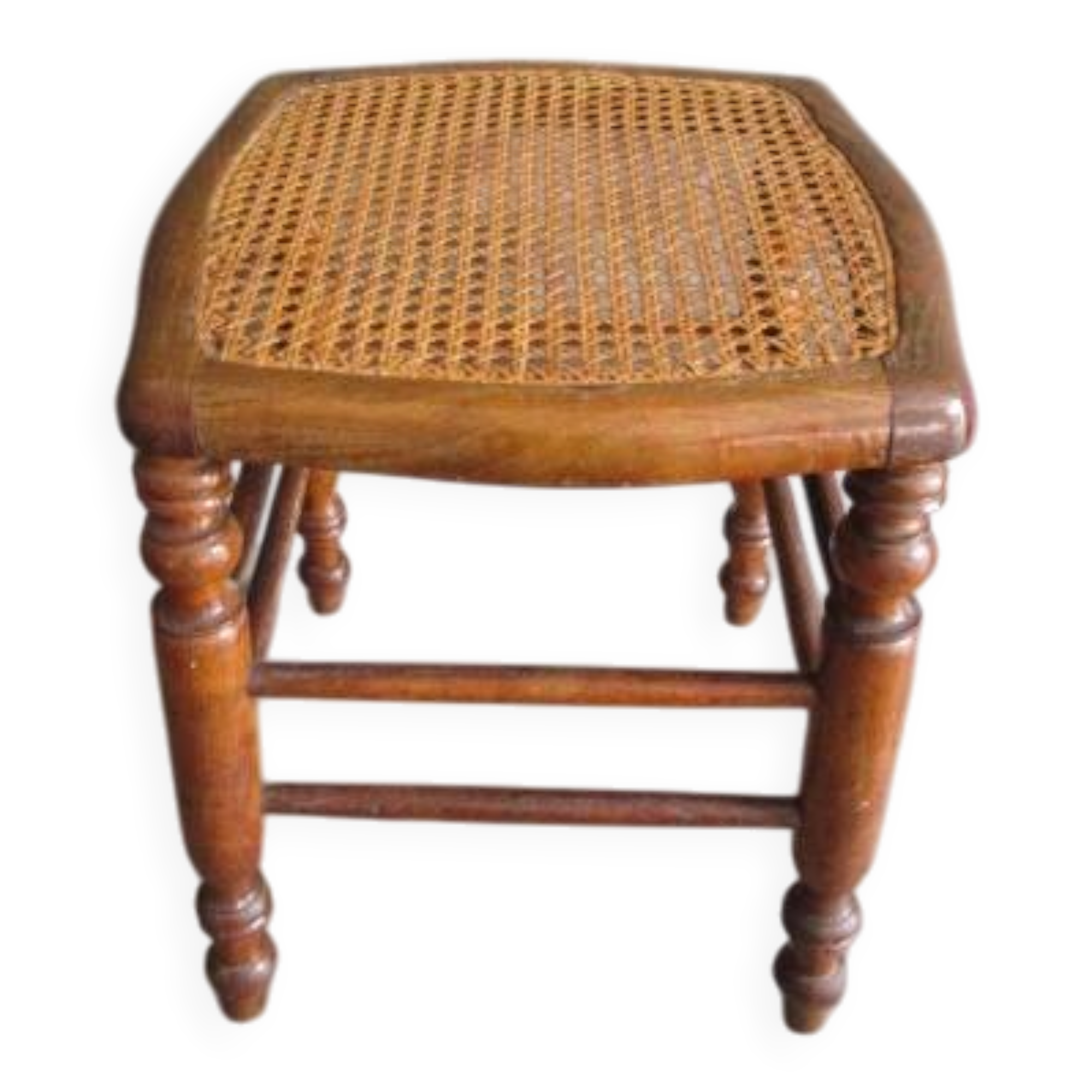 Antique wooden stool with cane seat.