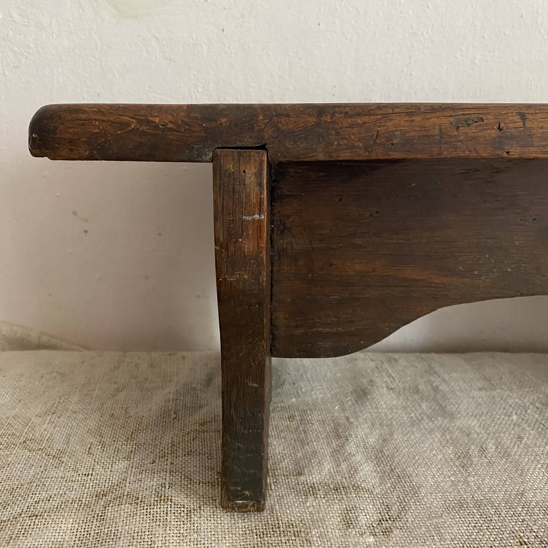 Old low stool made of solid wood