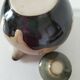 Vintage ceramic teapot with a flame design.