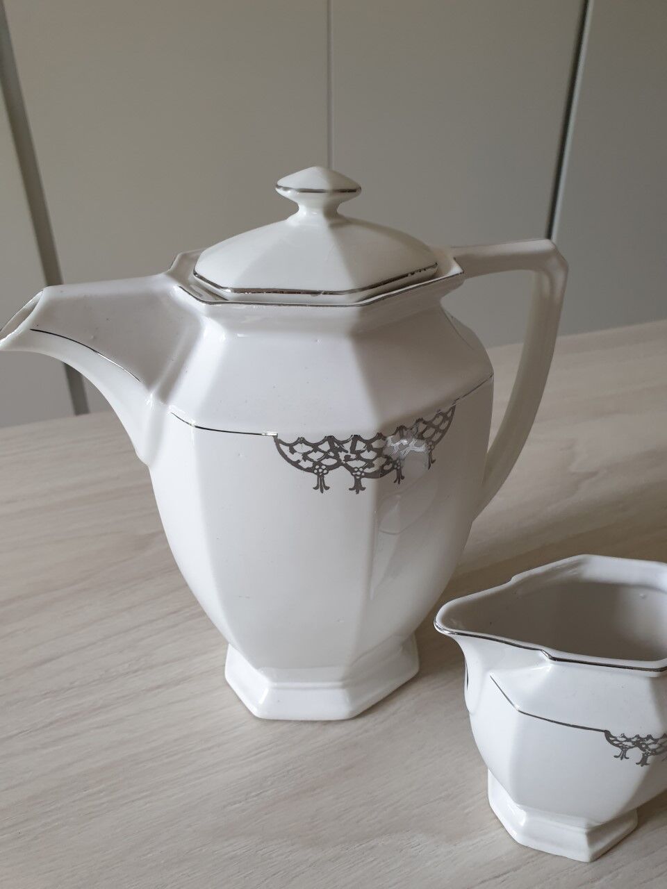 Old coffee maker and its milk pot