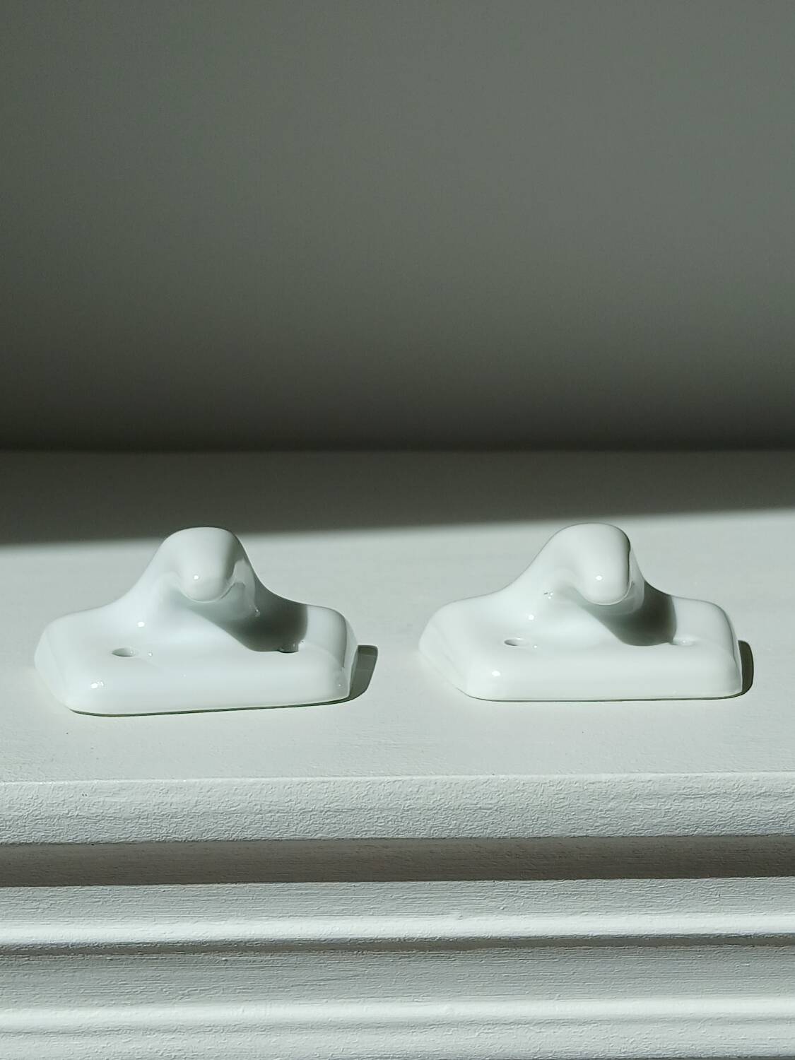 Set of two porcelain tea towel holders
