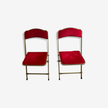 Set of two red and brass folding velvet opera chairs