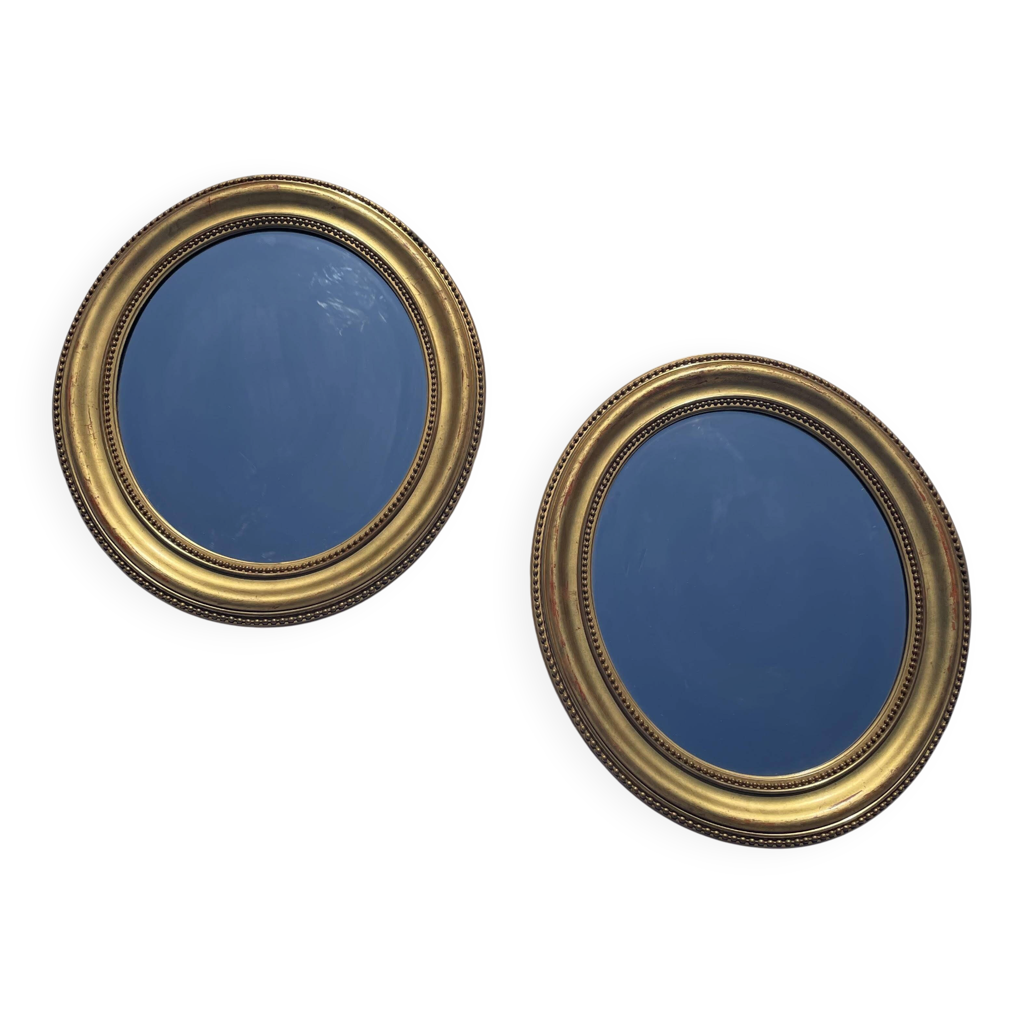 Duo de miroirs ovales et dorés en bois