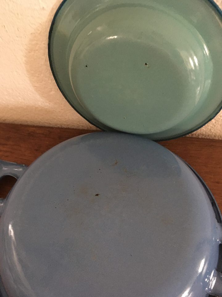 Two matching enameled dishes in green and blue