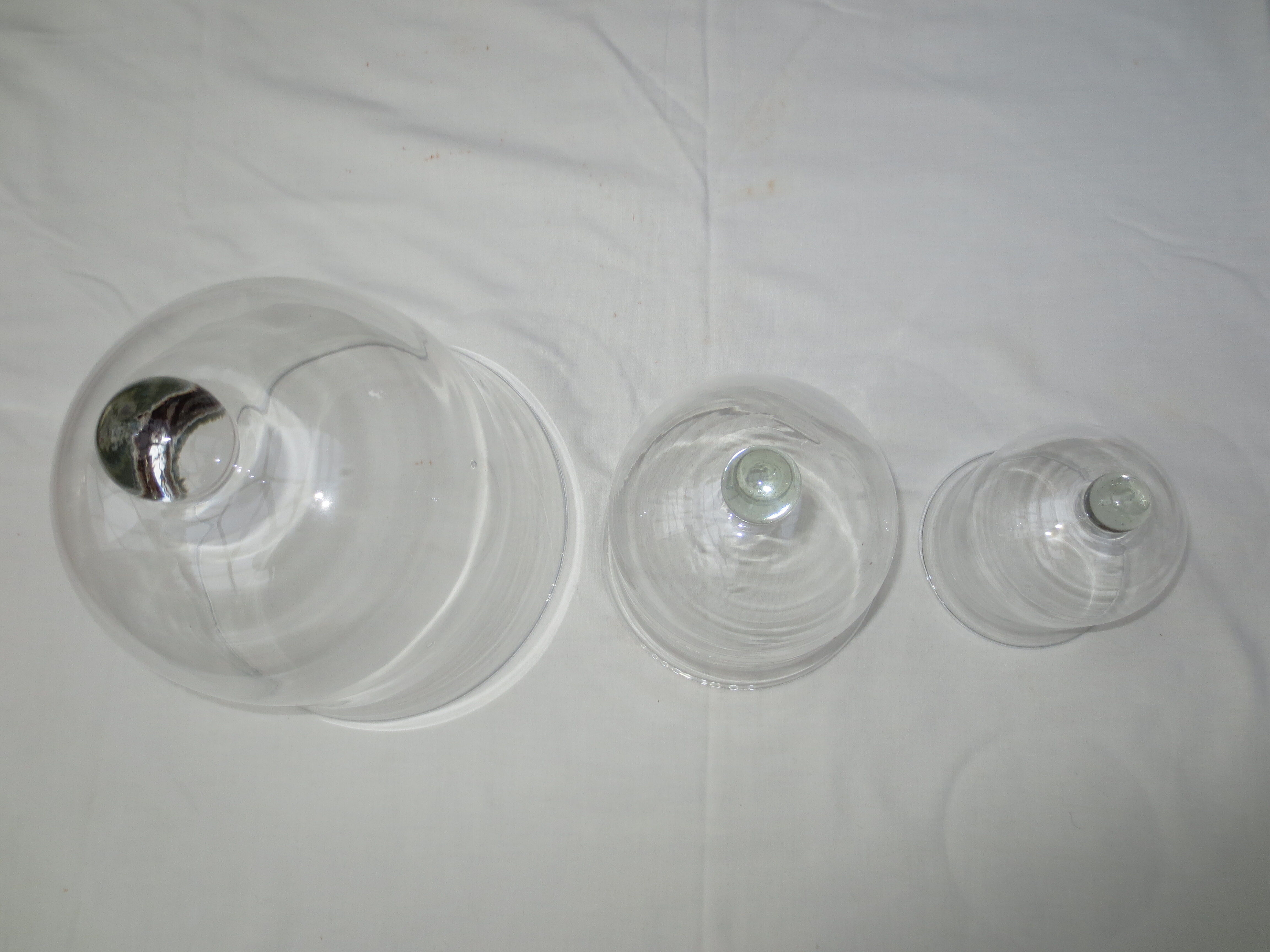 trio of old bells in transparent glass