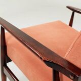 Mid-century modern armchair in coral red designed by H. Lis.