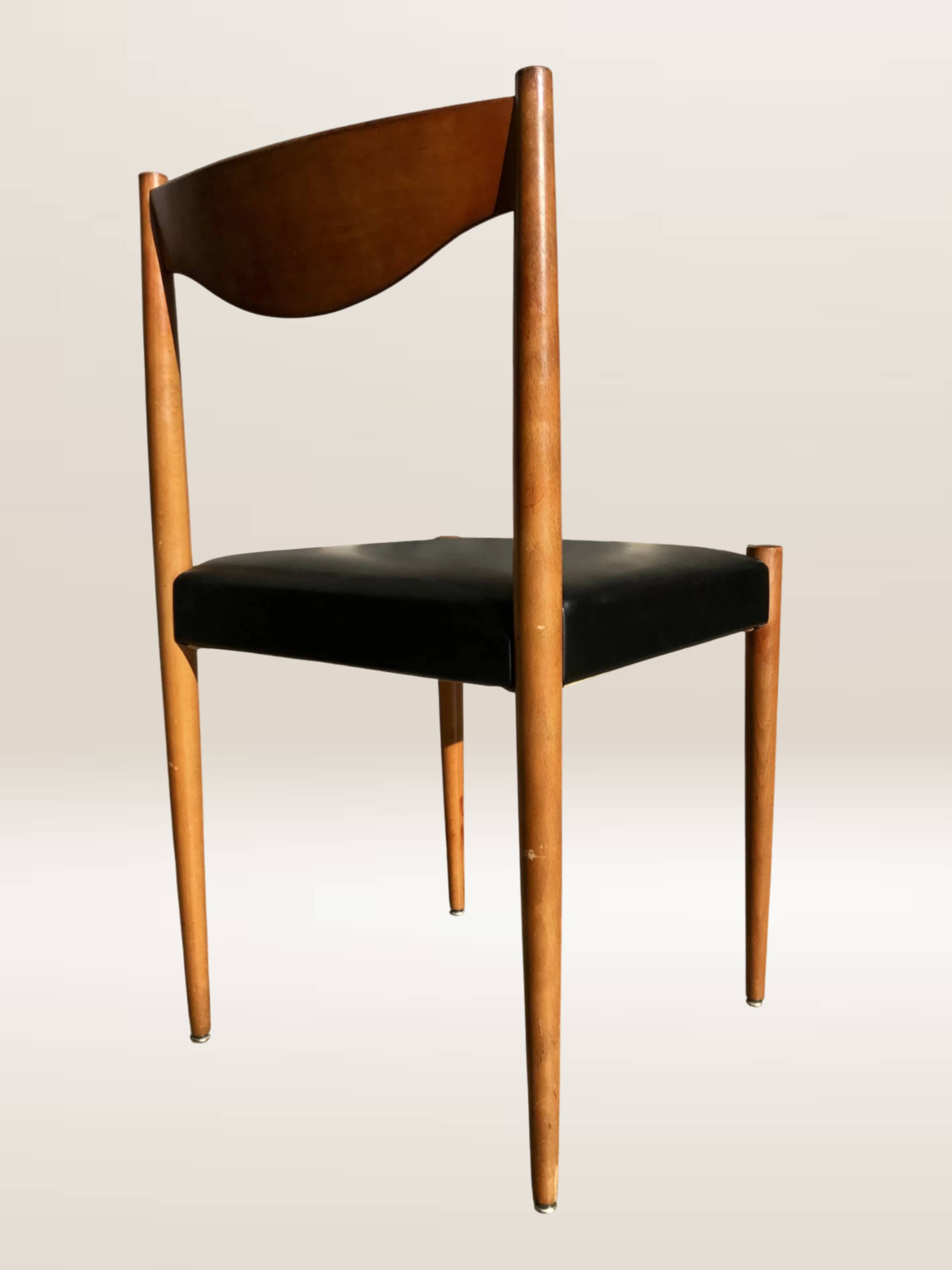 Set of 6 modernist chairs with black faux leather seats.