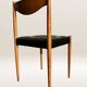 Set of 6 modernist chairs with black faux leather seats.