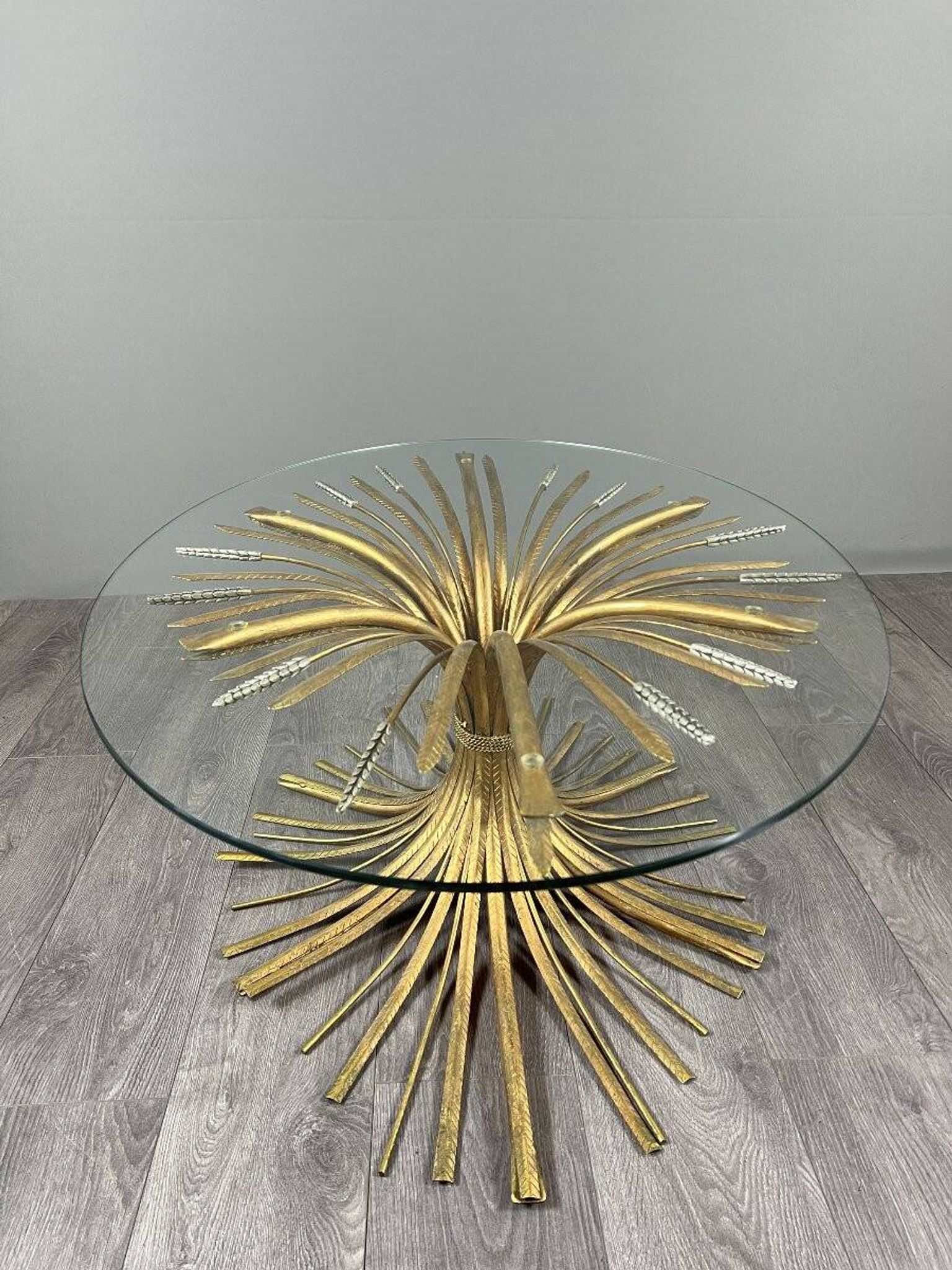 Gold metal and glass coffee table, 20th century, in the style of Robert Goos.
