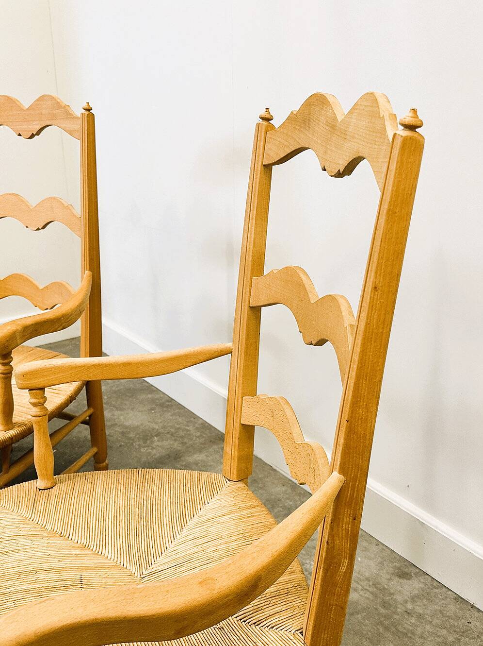 Pair of French Provencal Radassier beech chairs and ottoman, with rush seating.