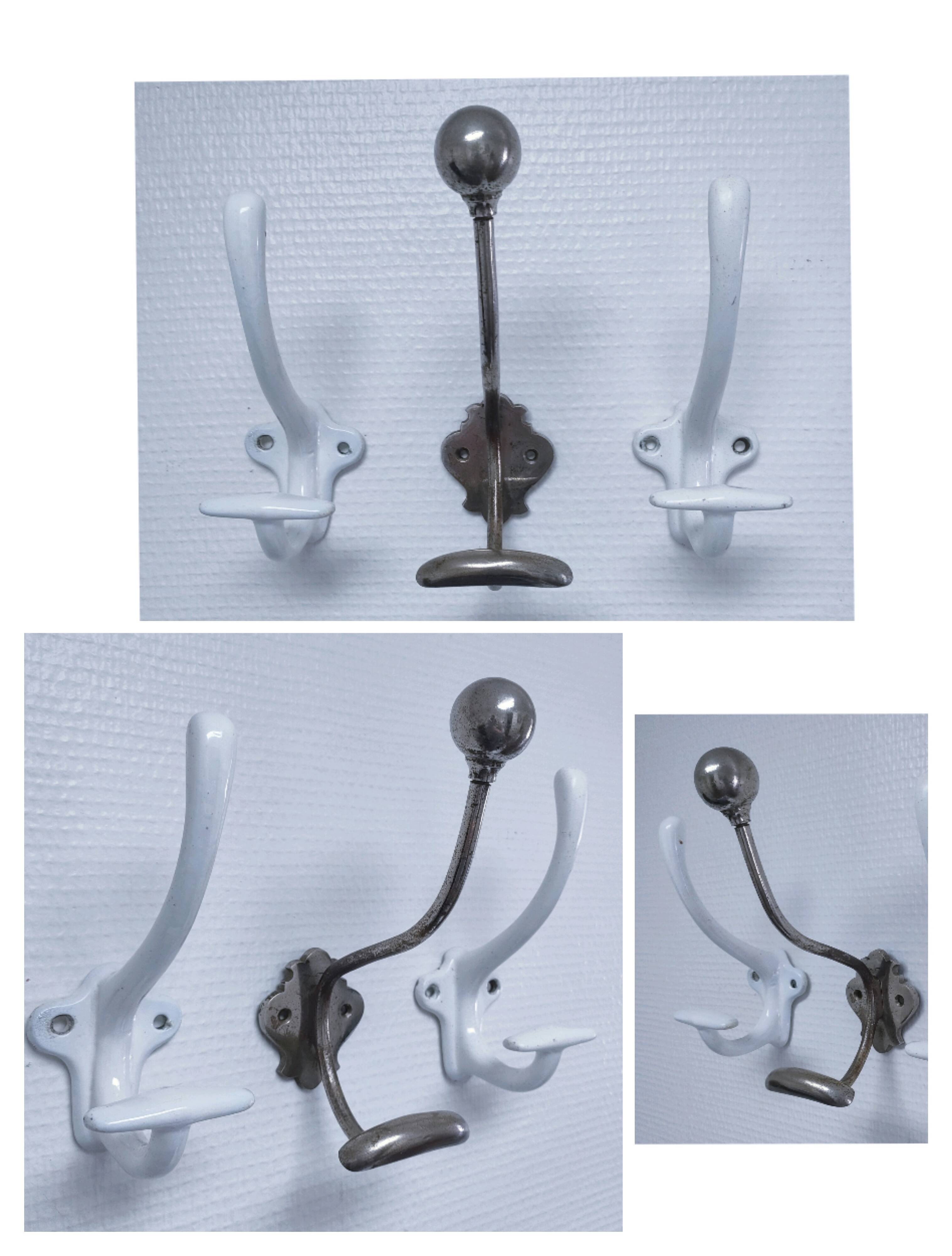 Three enameled cast iron coat hooks and vintage patina metal