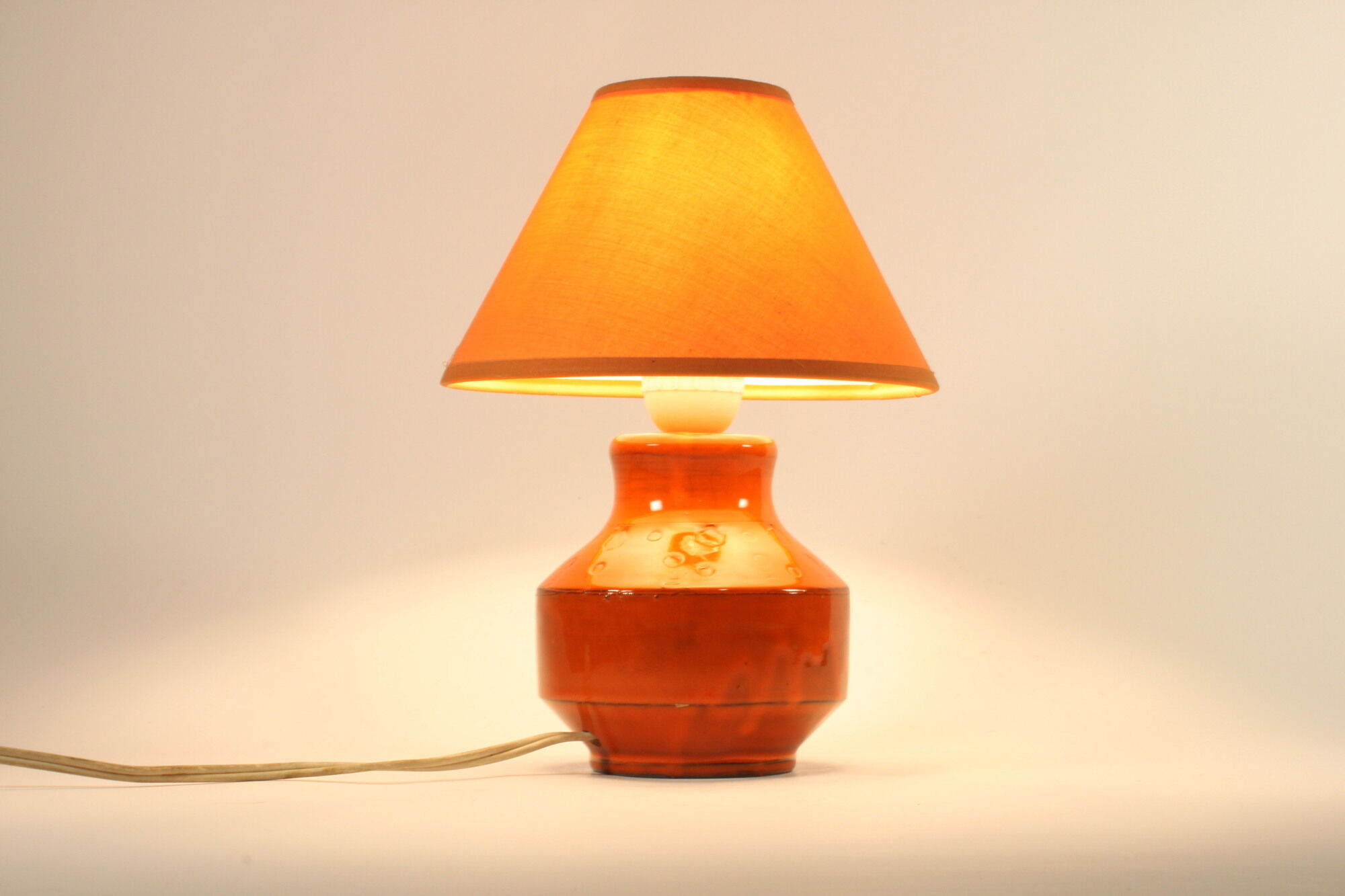 Orange ceramic table lamp with geometric imprints, 1970s.