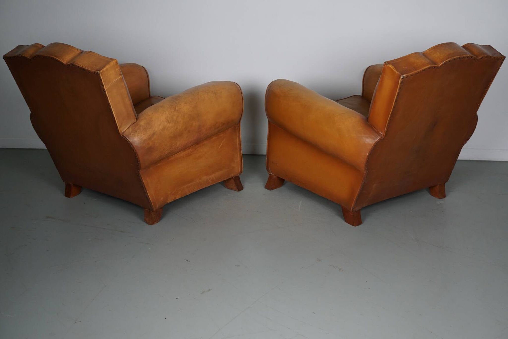 Pair of French Cognac Moustache Back Leather Club Chairs, 1950s