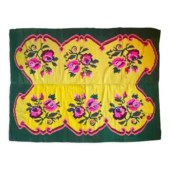 Vintage wool rug with pink flowers on green and yellow background made by hand in Transylvania