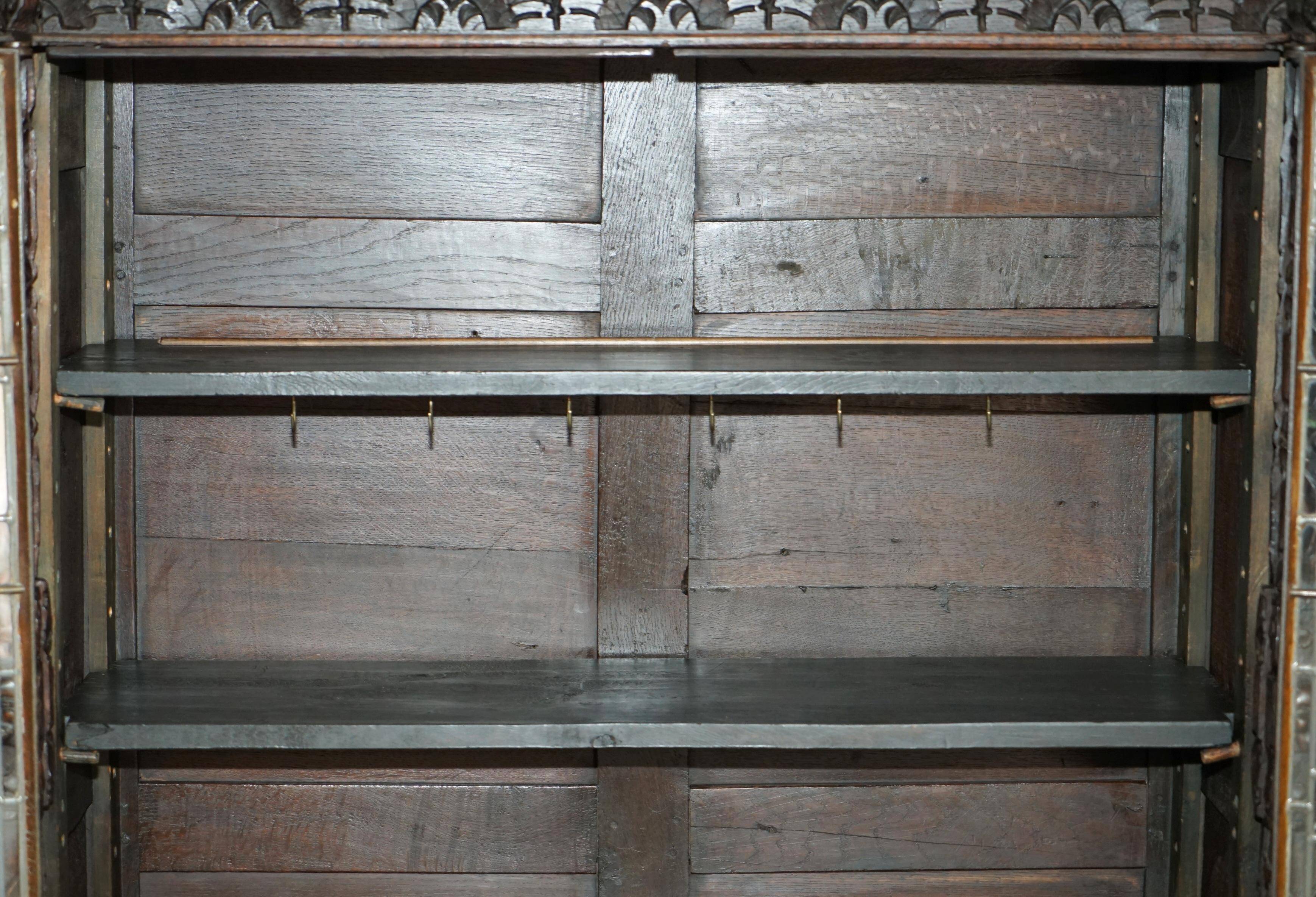 Jacobean hardwood library with carved panels and glass doors.