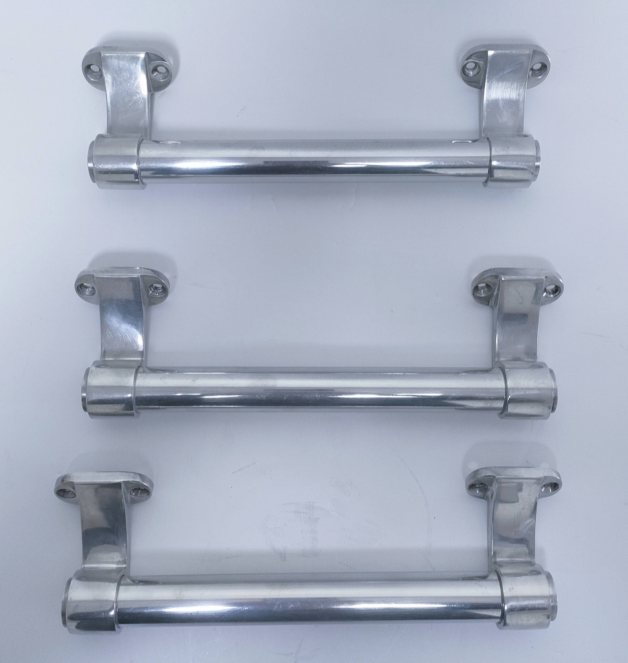 three long aluminum shop handles from the mid-20th century