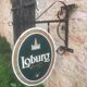 Double-sided "Loburg Beer" metal sign on wrought iron bracket