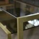 Designer coffee table with brass structure and black smoked glass, 1970s