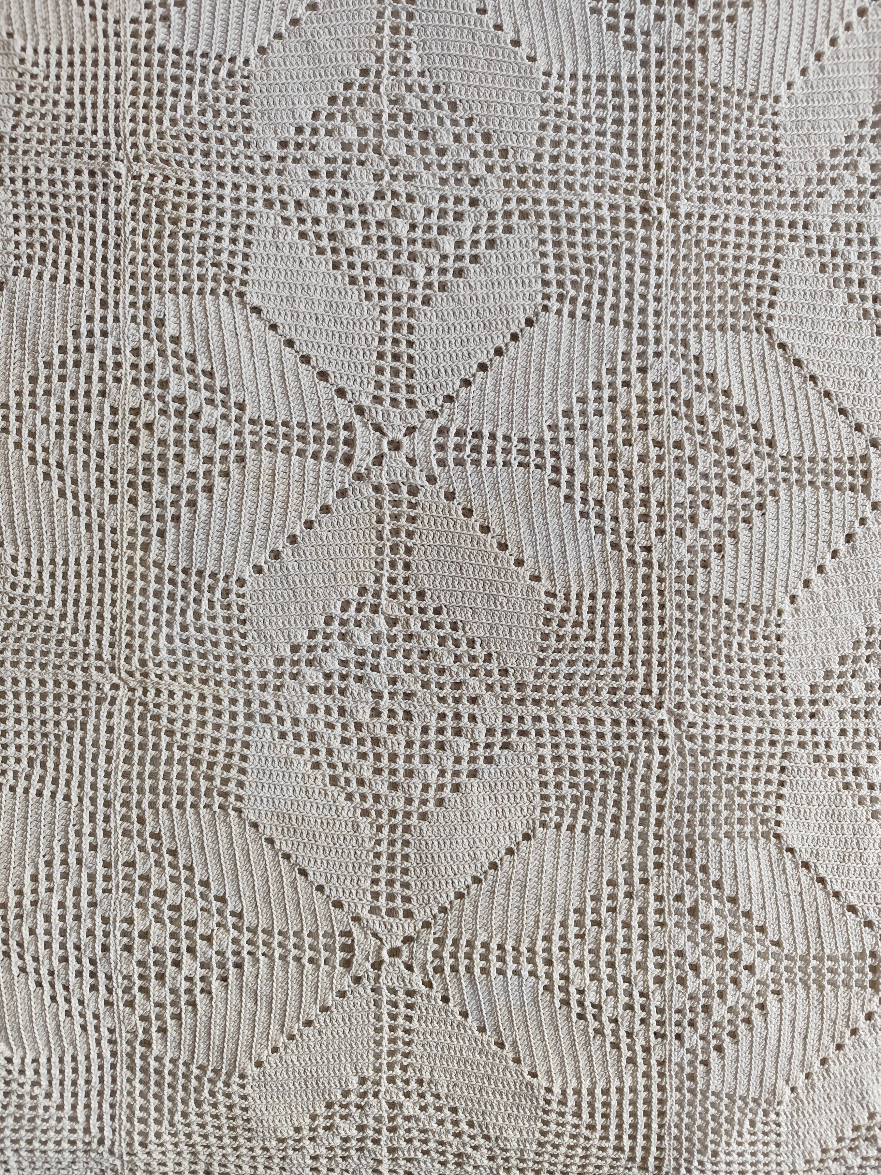 White cotton bedspread, crocheted sofa throw with star patterns