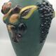 Green ceramic vase with polychrome decoration of fruits and vegetables in relief 33.5 cm