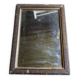 Antique mirror in black and gold wood