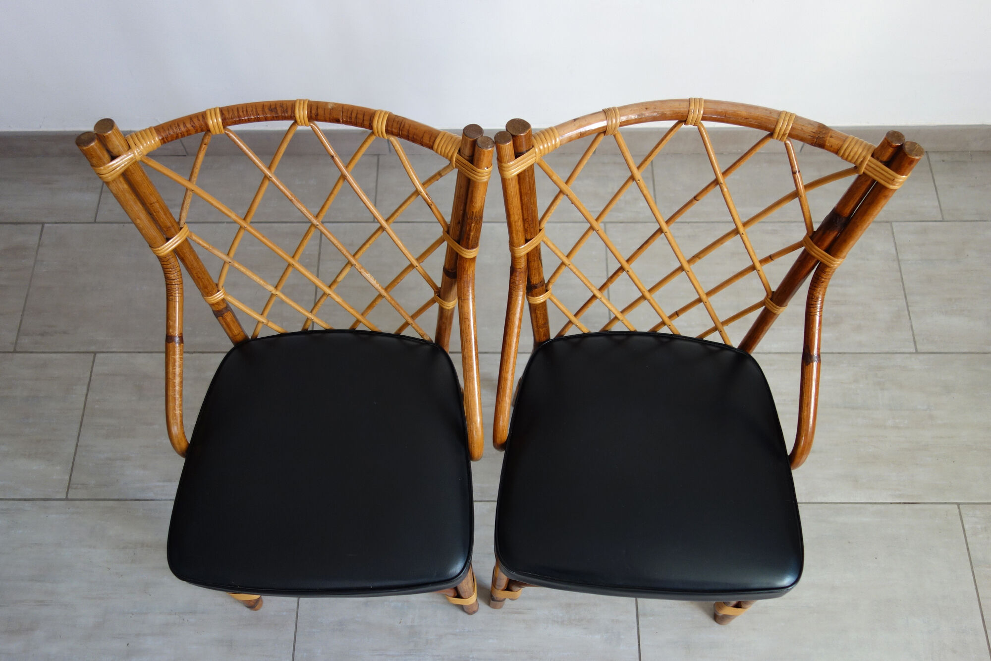Pair of rattan and black skai bamboo chairs, 60s