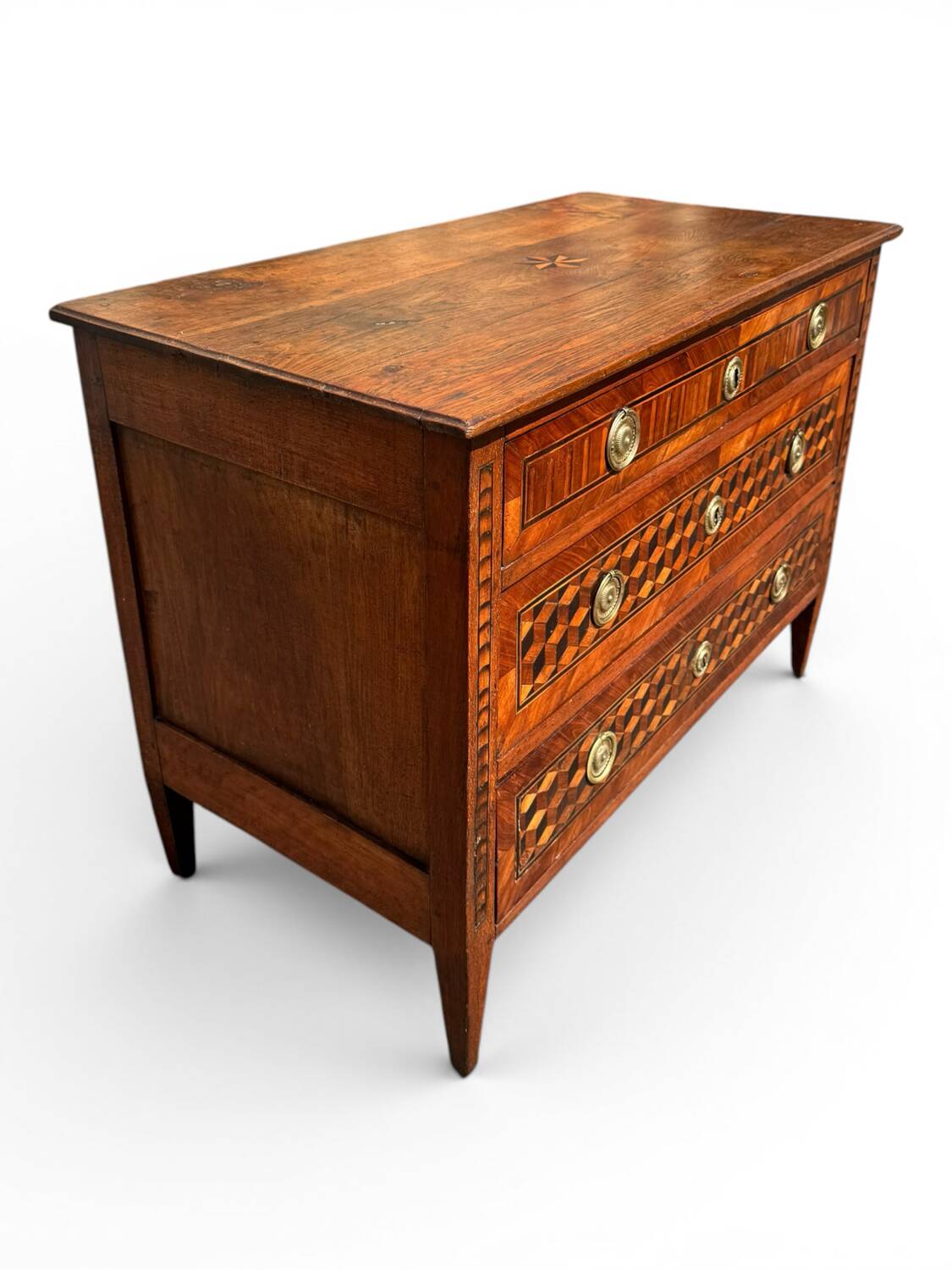 Louis XVI commode with marquetry featuring a design of precious wood cubes, 18th century.