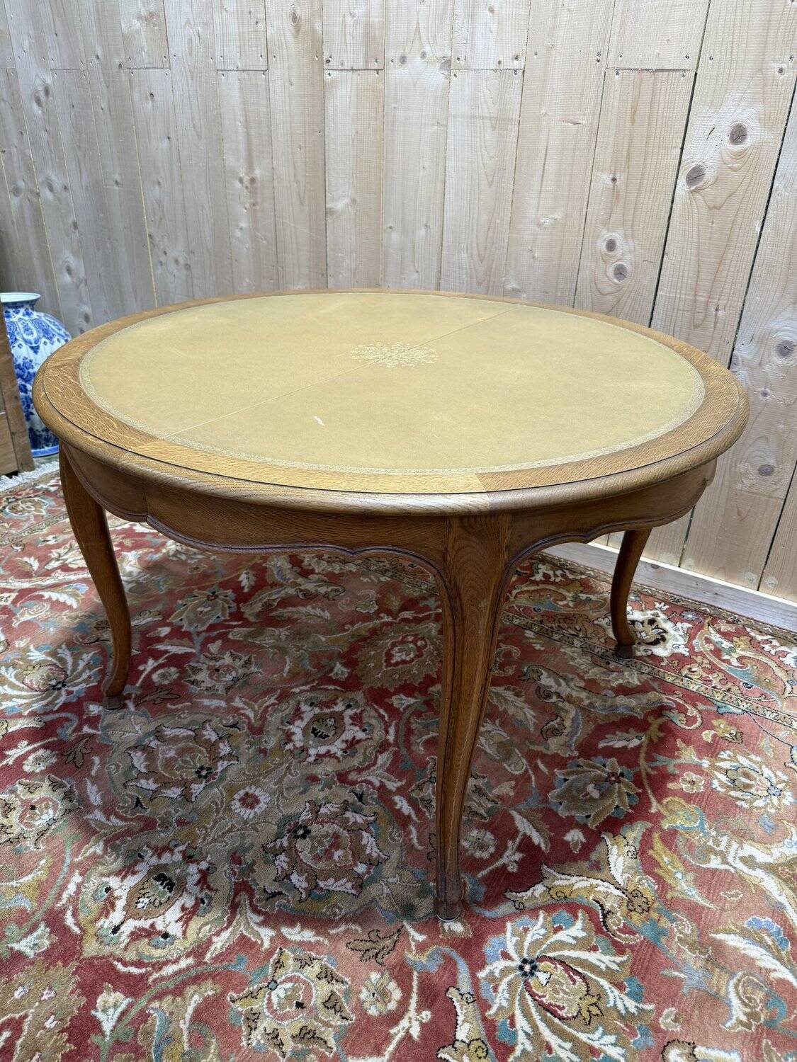 Round oak dining table with leather in Louis XV style.
