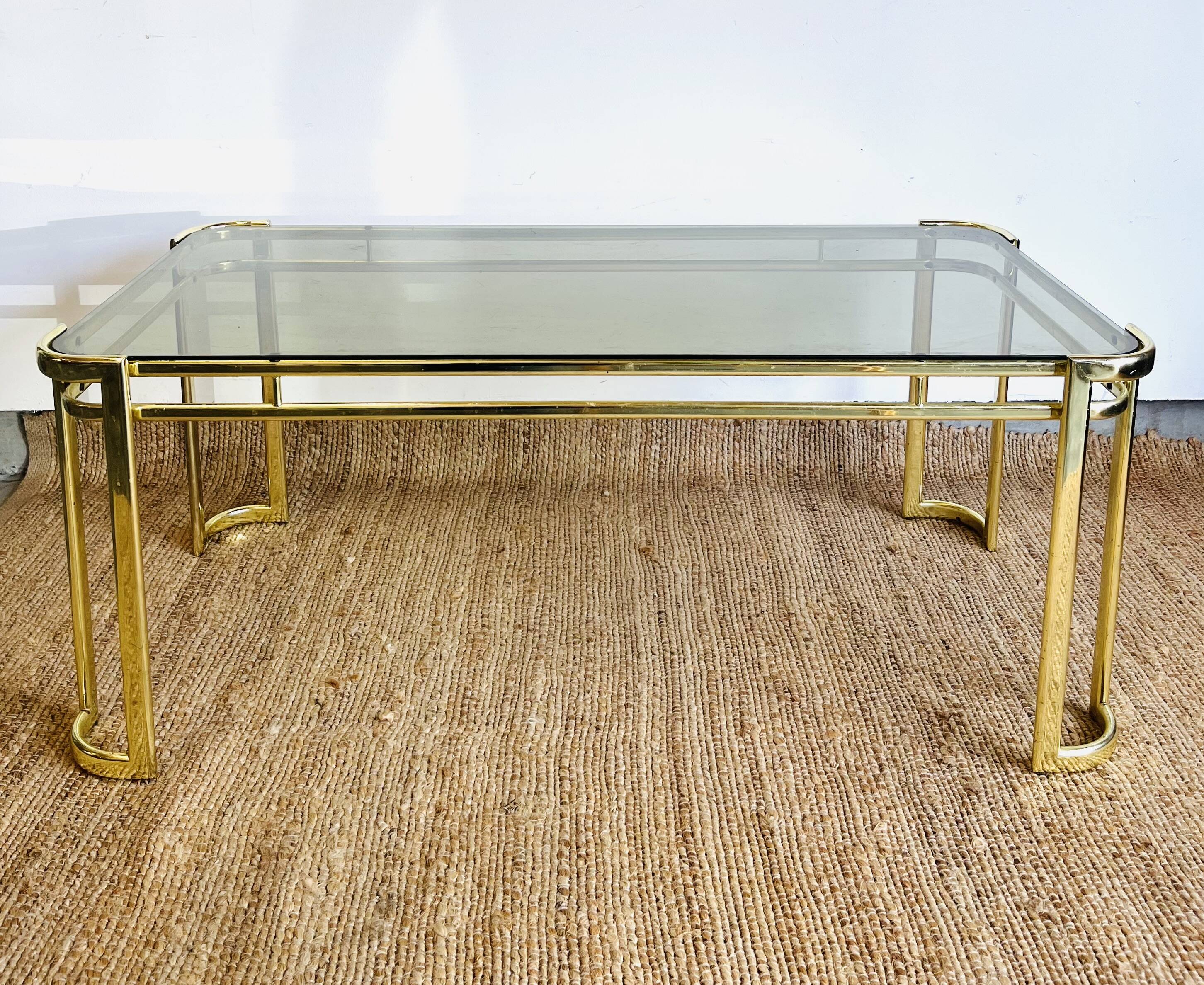 Gold metal and smoked glass coffee table – 1970s-624001