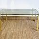 Gold metal and smoked glass coffee table – 1970s-624001