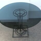 Wrought iron dining table with its round smoked glass top, vintage 1980