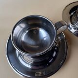 Two vintage mid century modern stainless steel coffee cups with saucer