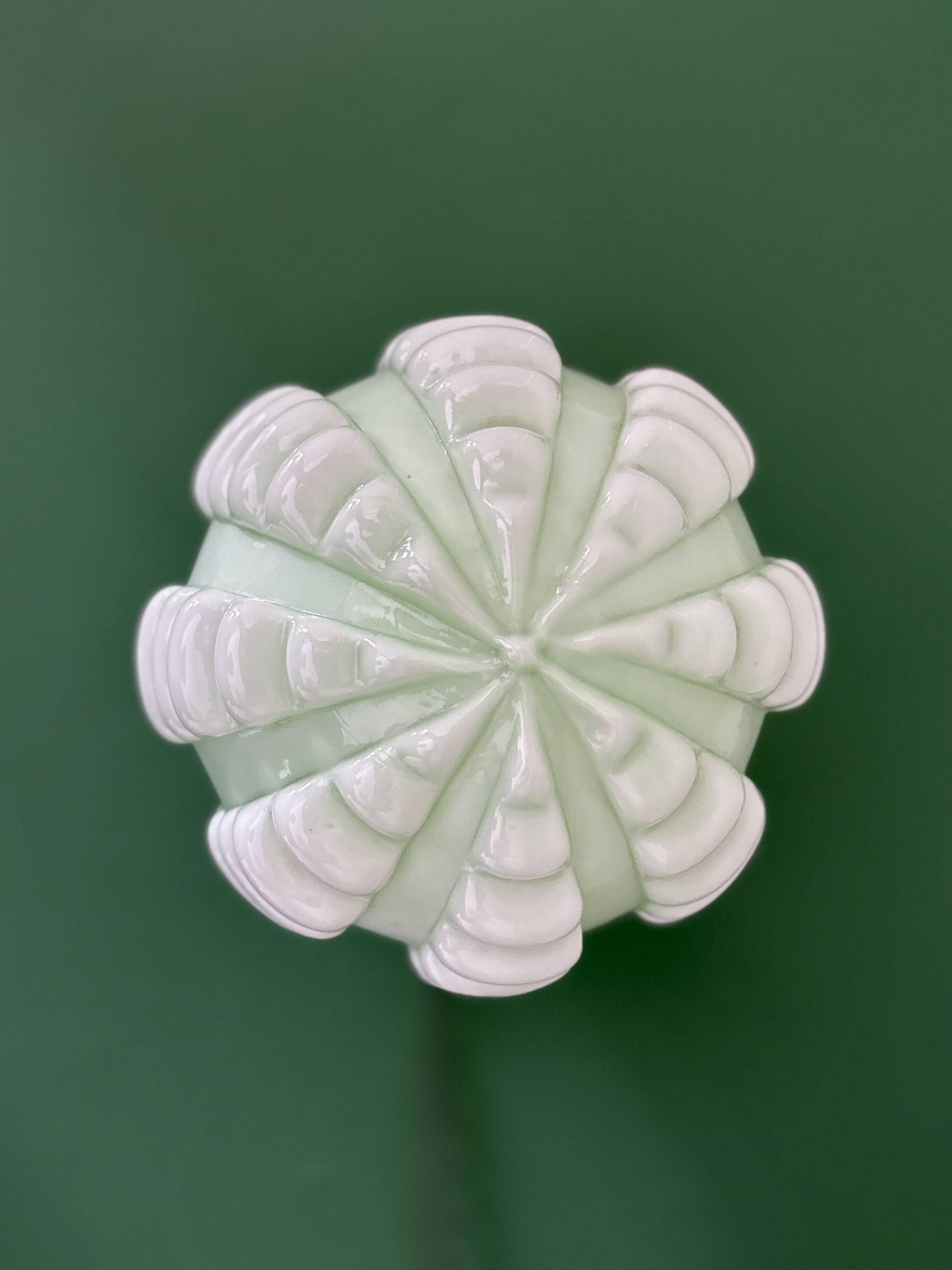 Vintage Art Deco globe wall light in pale green opaline.