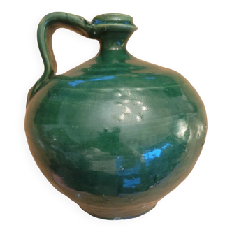 Old jug in green enamelled stoneware