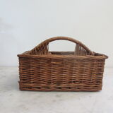 Basket carries glasses or cutlery in wicker.