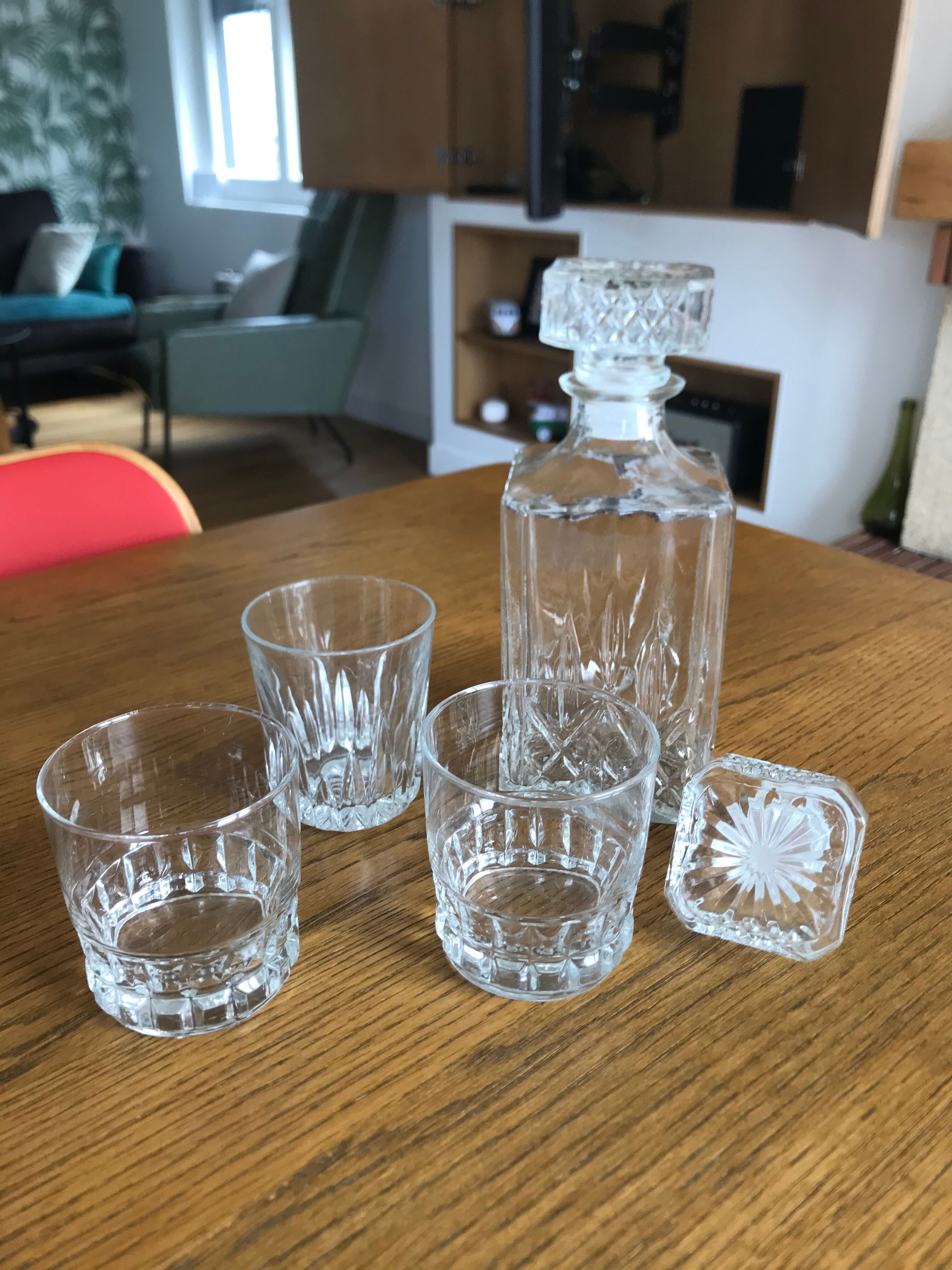 Mismatched decanter and whiskey glasses