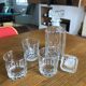 Mismatched decanter and whiskey glasses