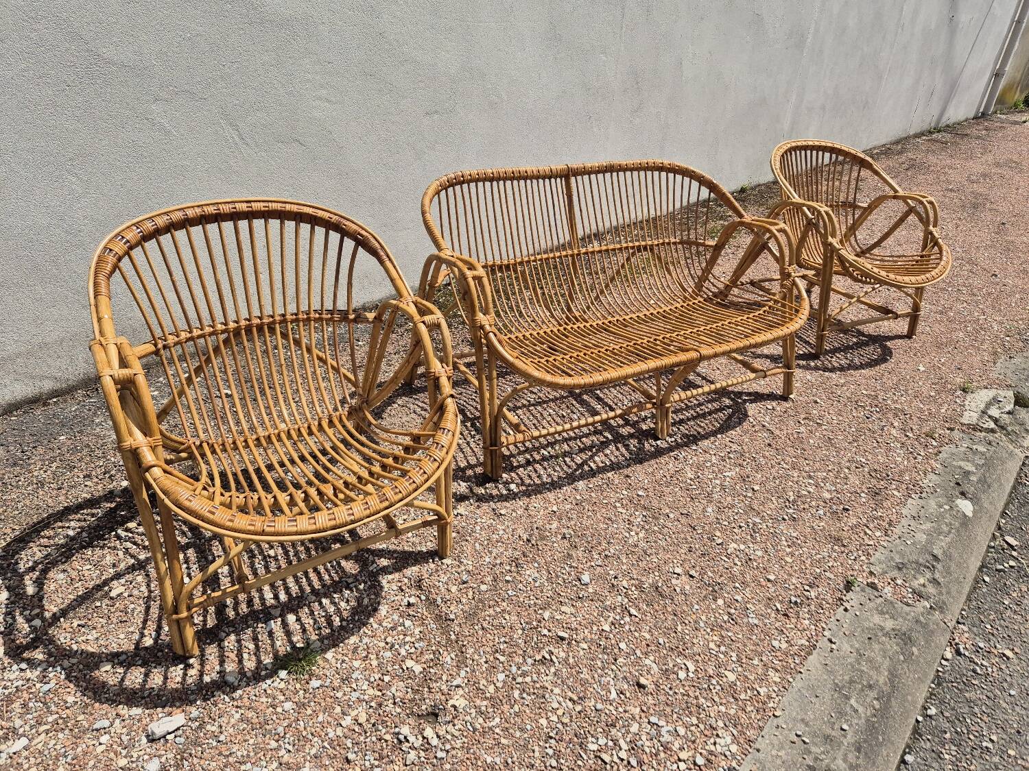 Rattan lounge with two armchairs and a vintage 1950s bench.