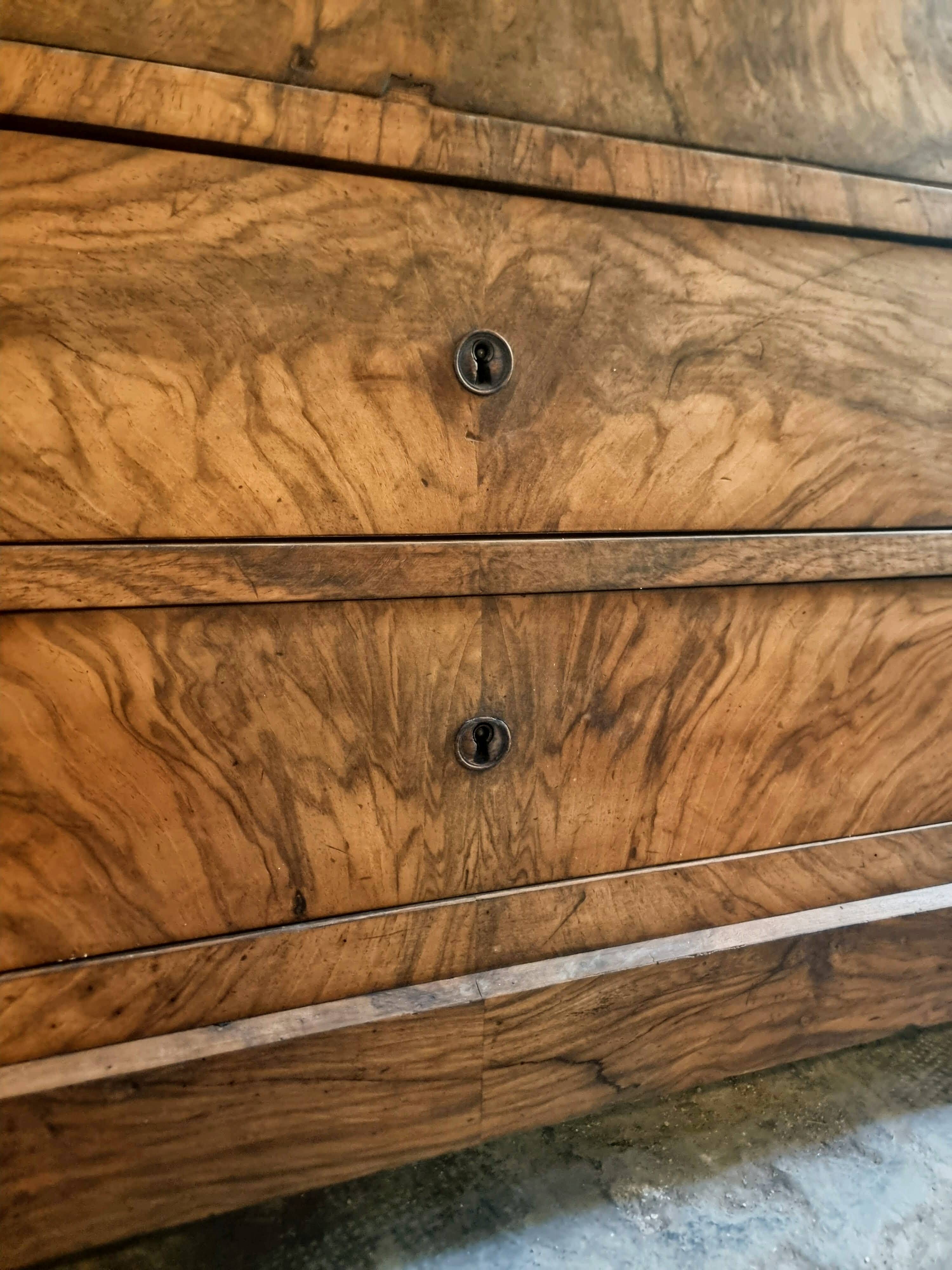 French antique walnut commode with a dark grey marble top, circa 1830–1860.