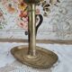 Brass pusher candle holder on oval frame