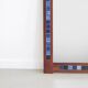 Rosewood mirror with blue ceramic tiles