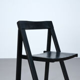 Set of three black folding chairs circa 1980