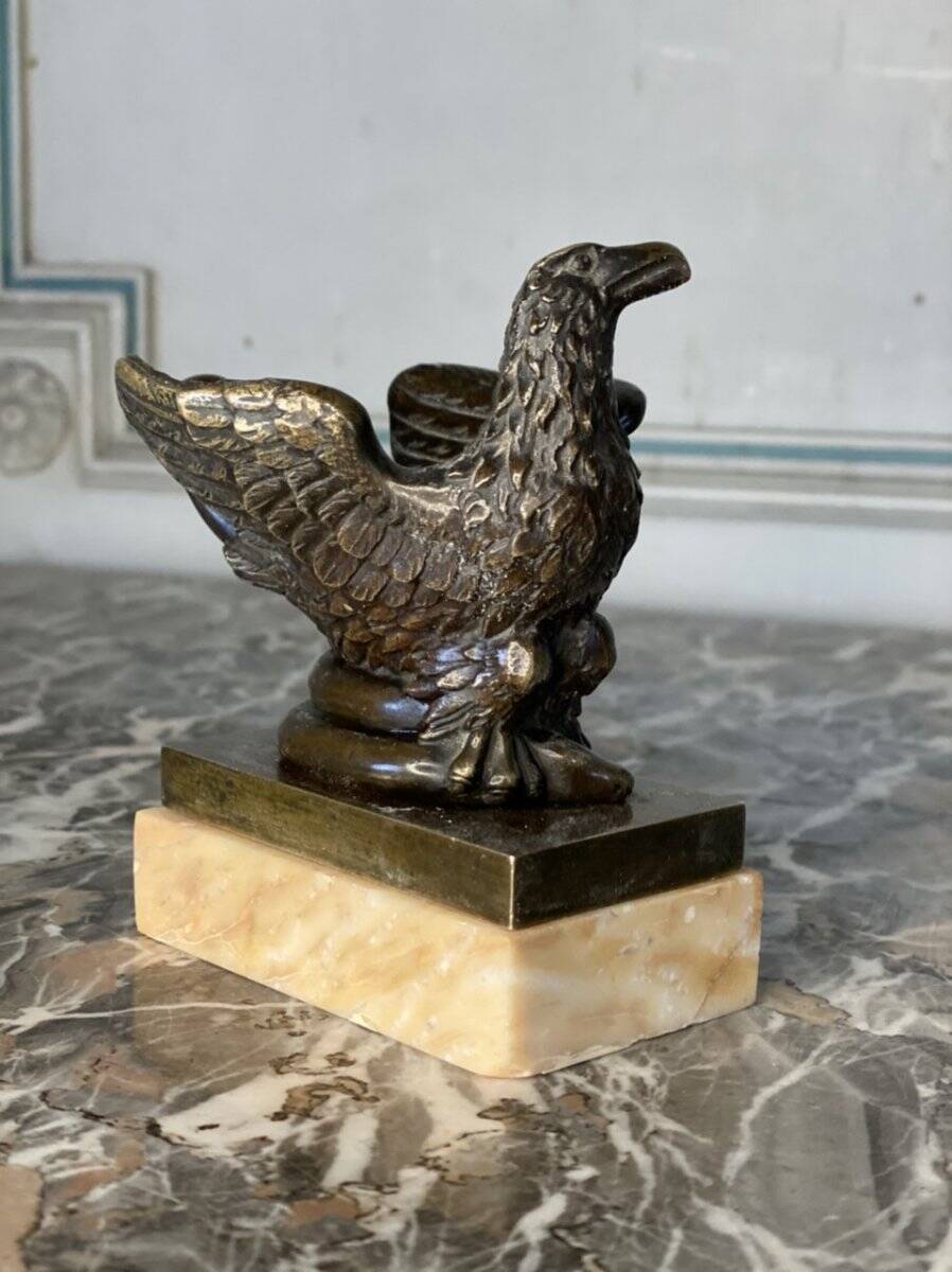 Eagle and serpent, bronze inkwell on a marble base.