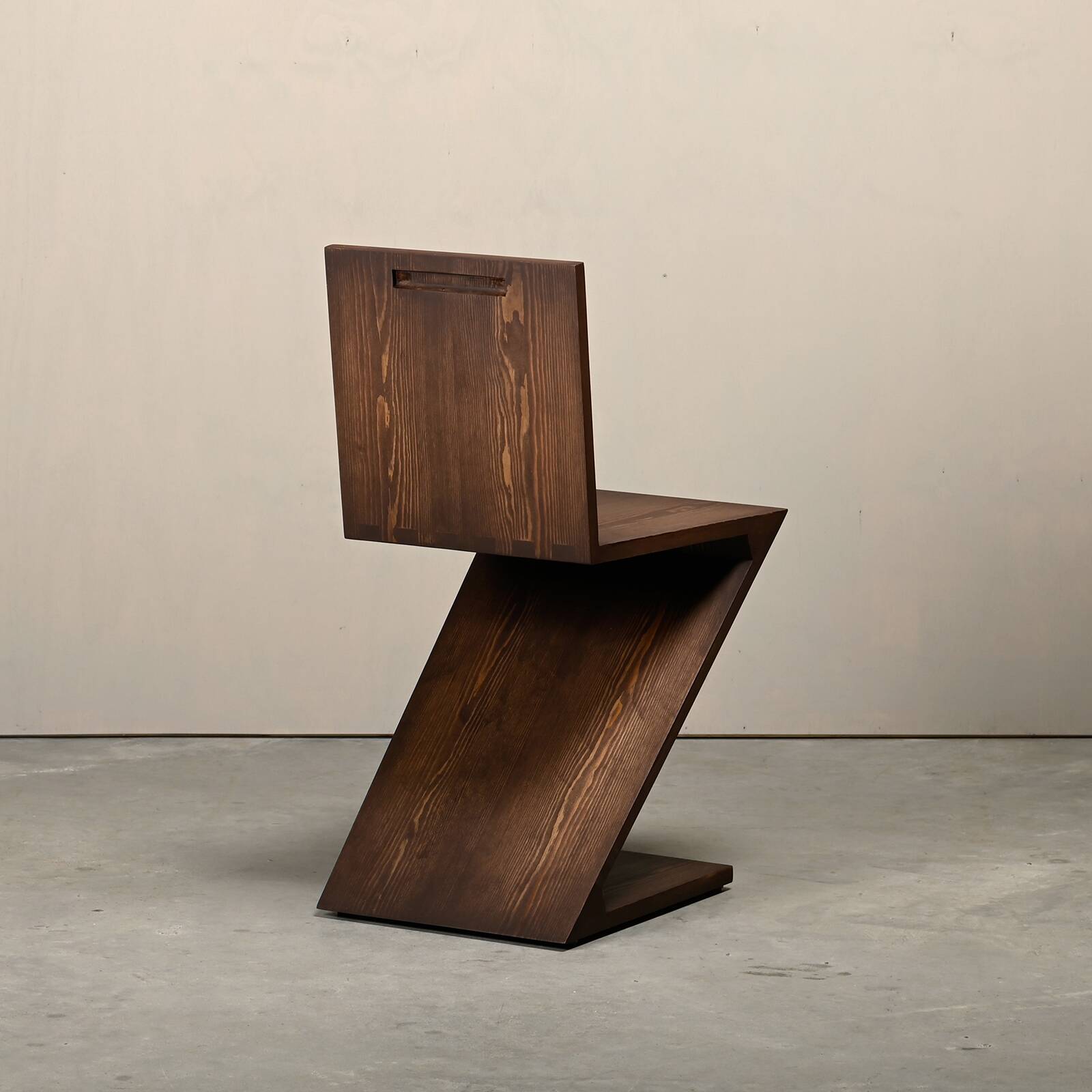 Gerrit Rietveld Zig Zag Chair is dark brown stained wood