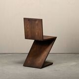 Gerrit Rietveld Zig Zag Chair is dark brown stained wood