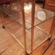 Trolley on wheels in gilded brass and beveled glass