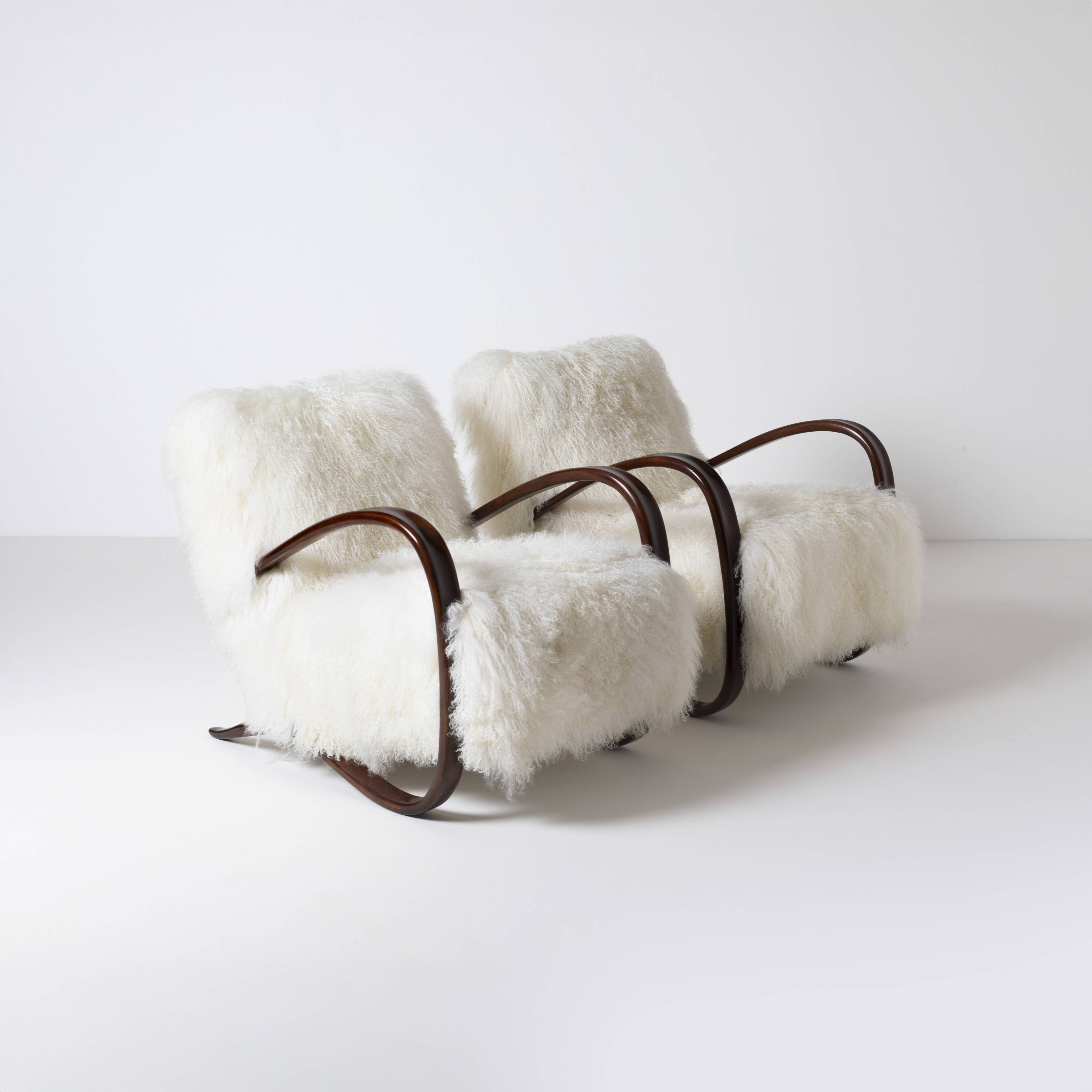 Pair of Jindrich Halabala H 269 lounge chairs in mongolian sheepskin