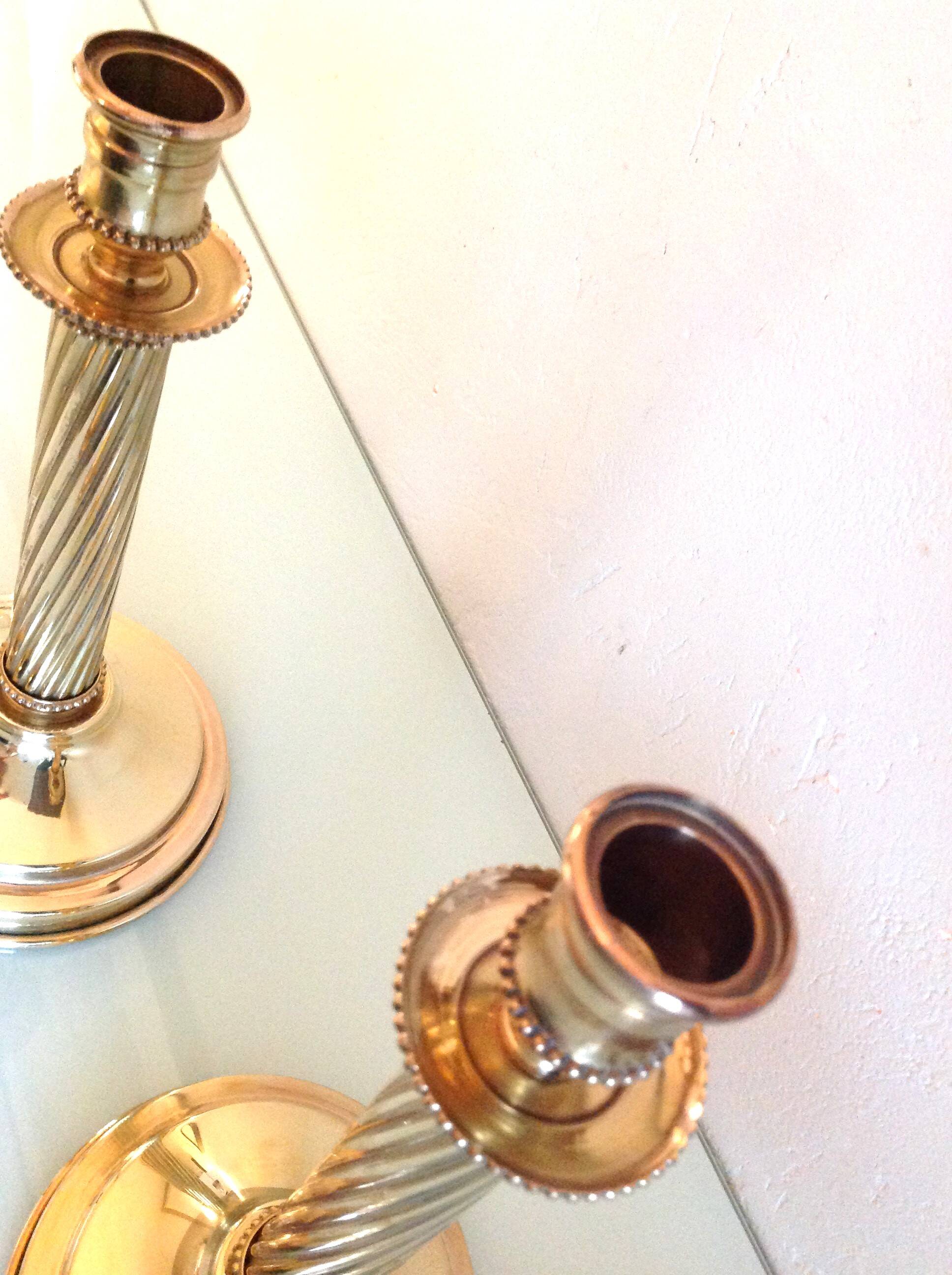 Pair of empire style brass candlesticks