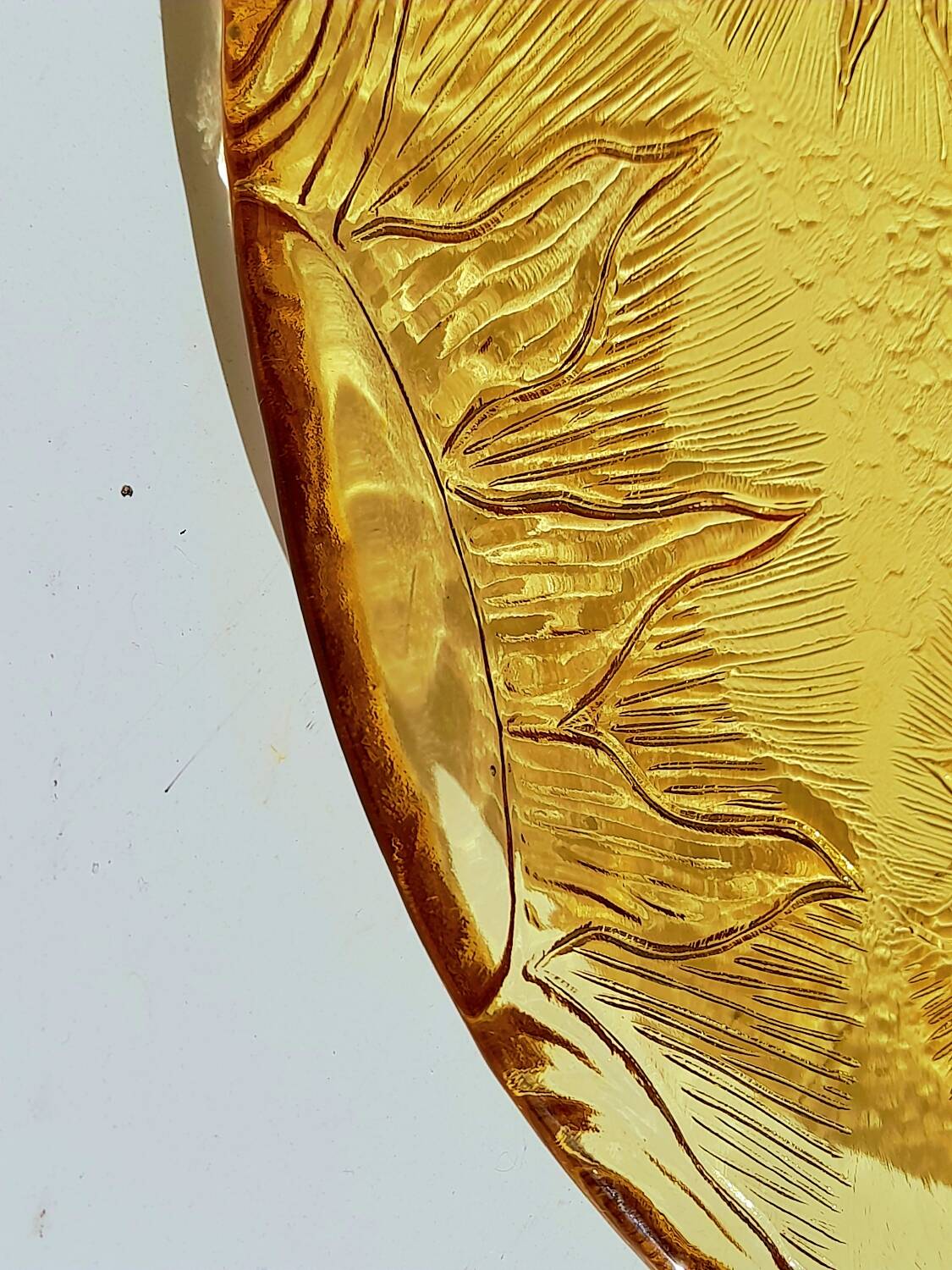 Glass plate decorated with suns, 1980.