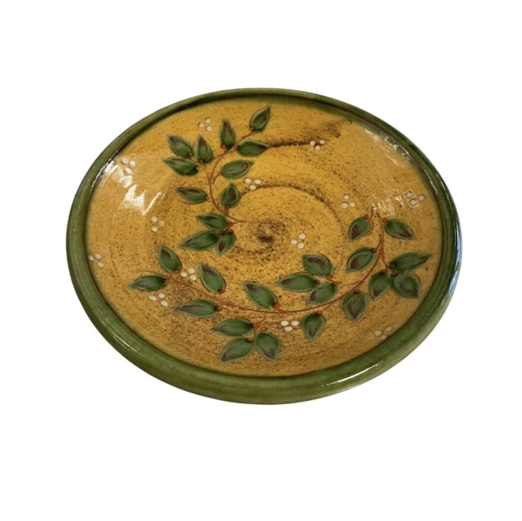 Decorative glazed terracotta plate with olive leaf pattern.